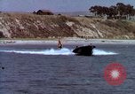 Image of motorboat pulling man and woman balanced on aquaplane United States USA, 1939, second 21 stock footage video 65675051556