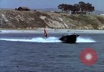 Image of motorboat pulling man and woman balanced on aquaplane United States USA, 1939, second 22 stock footage video 65675051556