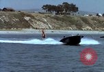 Image of motorboat pulling man and woman balanced on aquaplane United States USA, 1939, second 23 stock footage video 65675051556