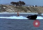 Image of motorboat pulling man and woman balanced on aquaplane United States USA, 1939, second 24 stock footage video 65675051556