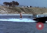 Image of motorboat pulling man and woman balanced on aquaplane United States USA, 1939, second 25 stock footage video 65675051556