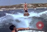 Image of motorboat pulling man and woman balanced on aquaplane United States USA, 1939, second 26 stock footage video 65675051556