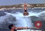 Image of motorboat pulling man and woman balanced on aquaplane United States USA, 1939, second 27 stock footage video 65675051556
