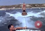 Image of motorboat pulling man and woman balanced on aquaplane United States USA, 1939, second 29 stock footage video 65675051556