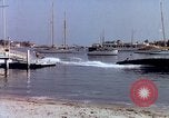 Image of motorboat pulling man and woman balanced on aquaplane United States USA, 1939, second 30 stock footage video 65675051556