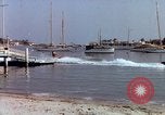 Image of motorboat pulling man and woman balanced on aquaplane United States USA, 1939, second 31 stock footage video 65675051556