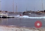 Image of motorboat pulling man and woman balanced on aquaplane United States USA, 1939, second 32 stock footage video 65675051556