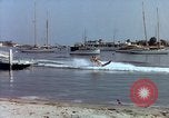Image of motorboat pulling man and woman balanced on aquaplane United States USA, 1939, second 33 stock footage video 65675051556