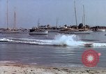 Image of motorboat pulling man and woman balanced on aquaplane United States USA, 1939, second 34 stock footage video 65675051556