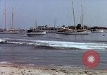 Image of motorboat pulling man and woman balanced on aquaplane United States USA, 1939, second 35 stock footage video 65675051556