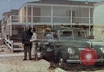 Image of motorboat pulling man and woman balanced on aquaplane United States USA, 1939, second 37 stock footage video 65675051556