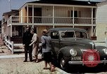 Image of motorboat pulling man and woman balanced on aquaplane United States USA, 1939, second 39 stock footage video 65675051556