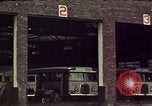 Image of buses in garage United States USA, 1937, second 15 stock footage video 65675051568