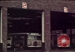 Image of buses in garage United States USA, 1937, second 16 stock footage video 65675051568