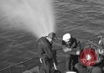 Image of U.S. sailors test fire hose on an LST Portland England United Kingdom, 1944, second 13 stock footage video 65675051842