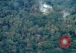 Image of smoky jungle Vietnam, 1967, second 17 stock footage video 65675051865