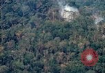 Image of smoky jungle Vietnam, 1967, second 18 stock footage video 65675051865