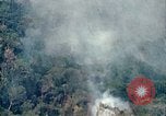 Image of smoky jungle Vietnam, 1967, second 23 stock footage video 65675051865