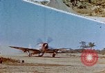 Image of Pilot examines flak damage to his P-47 aircraft Corsica France, 1944, second 1 stock footage video 65675051897