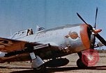 Image of Pilot examines flak damage to his P-47 aircraft Corsica France, 1944, second 10 stock footage video 65675051897
