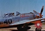 Image of Pilot examines flak damage to his P-47 aircraft Corsica France, 1944, second 12 stock footage video 65675051897