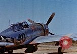 Image of Pilot examines flak damage to his P-47 aircraft Corsica France, 1944, second 14 stock footage video 65675051897