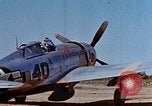 Image of Pilot examines flak damage to his P-47 aircraft Corsica France, 1944, second 15 stock footage video 65675051897
