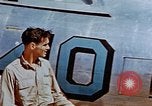 Image of Pilot examines flak damage to his P-47 aircraft Corsica France, 1944, second 21 stock footage video 65675051897