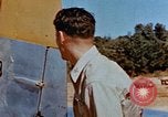 Image of Pilot examines flak damage to his P-47 aircraft Corsica France, 1944, second 29 stock footage video 65675051897