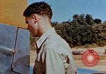 Image of Pilot examines flak damage to his P-47 aircraft Corsica France, 1944, second 30 stock footage video 65675051897