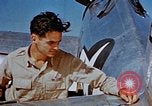 Image of Pilot examines flak damage to his P-47 aircraft Corsica France, 1944, second 34 stock footage video 65675051897