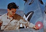 Image of Pilot examines flak damage to his P-47 aircraft Corsica France, 1944, second 35 stock footage video 65675051897