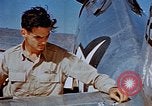 Image of Pilot examines flak damage to his P-47 aircraft Corsica France, 1944, second 36 stock footage video 65675051897