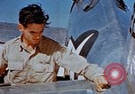 Image of Pilot examines flak damage to his P-47 aircraft Corsica France, 1944, second 37 stock footage video 65675051897