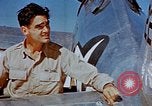 Image of Pilot examines flak damage to his P-47 aircraft Corsica France, 1944, second 38 stock footage video 65675051897