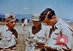 Image of Pilot examines flak damage to his P-47 aircraft Corsica France, 1944, second 55 stock footage video 65675051897