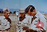 Image of Pilot examines flak damage to his P-47 aircraft Corsica France, 1944, second 56 stock footage video 65675051897