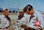 Image of Pilot examines flak damage to his P-47 aircraft Corsica France, 1944, second 57 stock footage video 65675051897
