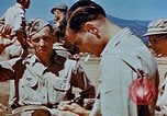 Image of Pilot examines flak damage to his P-47 aircraft Corsica France, 1944, second 59 stock footage video 65675051897