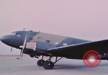 Image of camouflaged AC 47 aircraft Vietnam Bien Hoa Air Base, 1967, second 40 stock footage video 65675052032