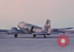 Image of camouflaged AC 47 aircraft Vietnam Bien Hoa Air Base, 1967, second 43 stock footage video 65675052033