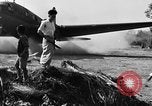 Image of Repair of U.S. C-46 aircraft with help of indigenous people Burma, 1944, second 56 stock footage video 65675052233