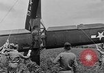Image of Inverted US Army Stinson L-5 plane on field Italy, 1944, second 52 stock footage video 65675052268