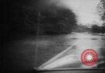 Image of rapid flowing water in streets United States USA, 1955, second 9 stock footage video 65675052615