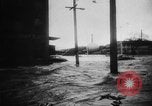 Image of rapid flowing water in streets United States USA, 1955, second 12 stock footage video 65675052615
