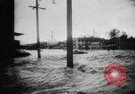 Image of rapid flowing water in streets United States USA, 1955, second 14 stock footage video 65675052615