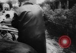 Image of rapid flowing water in streets United States USA, 1955, second 21 stock footage video 65675052615