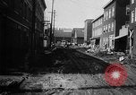 Image of rapid flowing water in streets United States USA, 1955, second 22 stock footage video 65675052615