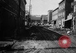 Image of rapid flowing water in streets United States USA, 1955, second 23 stock footage video 65675052615