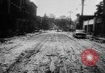 Image of rapid flowing water in streets United States USA, 1955, second 25 stock footage video 65675052615